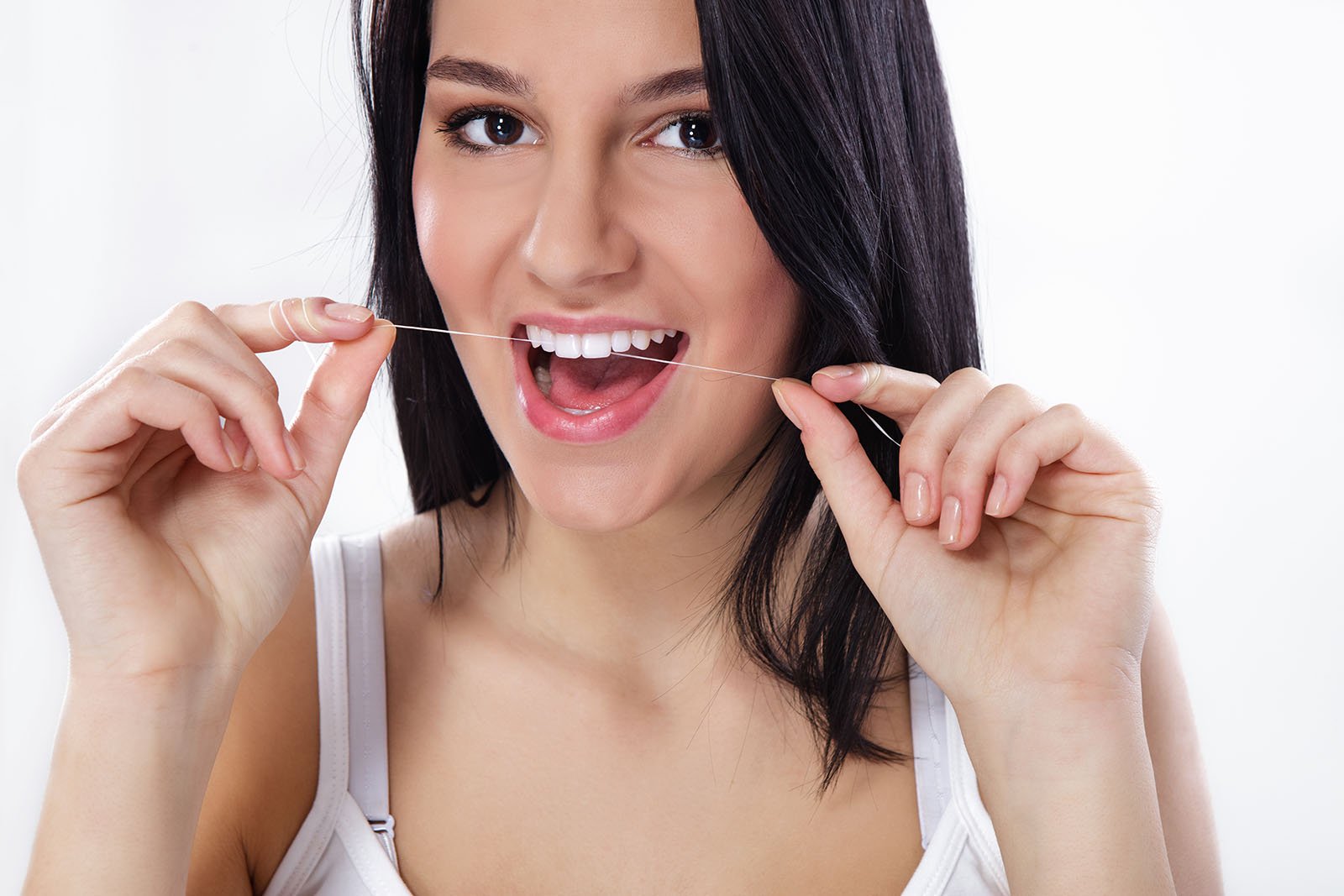 woman flossing her teeth